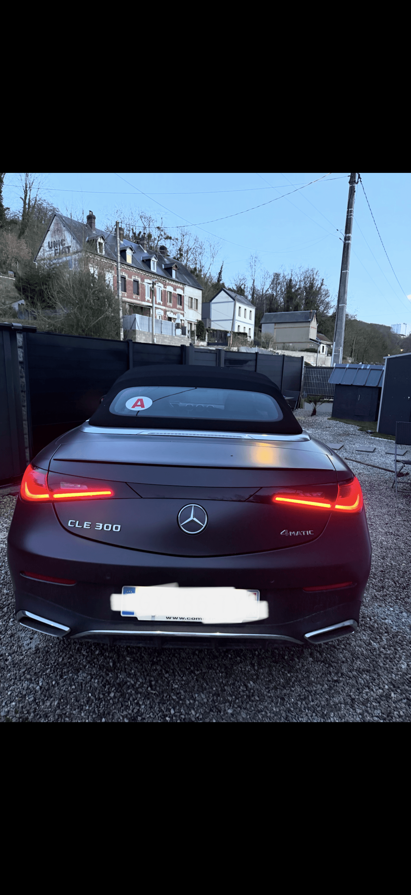 Mercedes CLE 300 parked outside a house